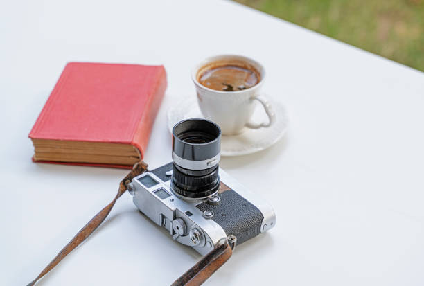 istock Vintage camera and book with a cup of coffee 1327847307