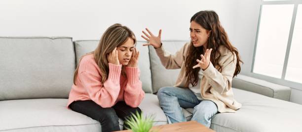 istock Young couple sitting on the sofa discussing at home. 1327848595