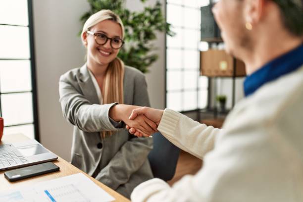 istock Two business executives shaking hands at the office. 1327849260