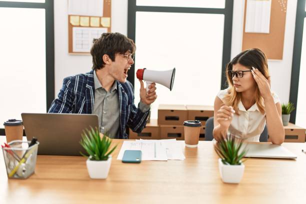 istock Businessman angry shouting his partner using megaphone at the office. 1327850211