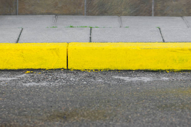 istock Sidewalk painted with yellow paints background 1327850550