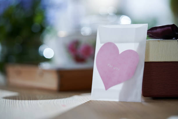 istock heart shape greeting card  with gift box and tea set on wooden table 1327851534
