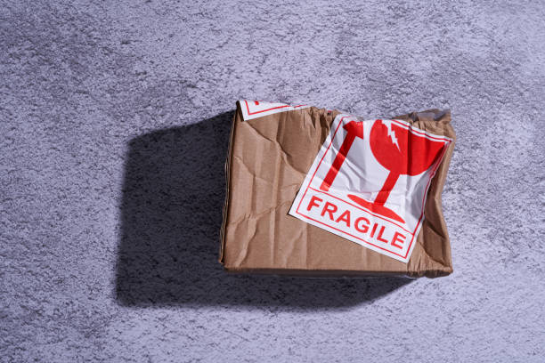 istock damaged parcel with fragile sticker on the floor 1327851623