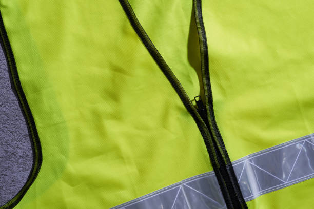 close up of yellow color safety vest with silver reflector - reflective clothing imagens e fotografias de stock