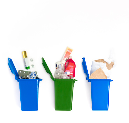 Three trash cans with rubbish on a white background. View from above. Garbage sorting concept