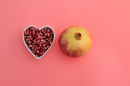 Red delicious apple with a love heart shape bitten into the flesh