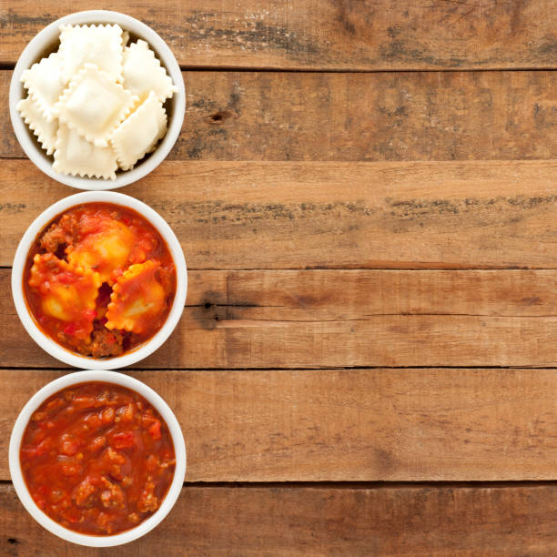 Bolognese ravioli Top view of three bowls with ravioli bolognese and its ingredients healthy eating red above studio shot stock pictures, royalty-free photos & images