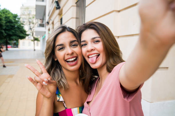 istock Two friends taking a selfie outdoors. 1327857611