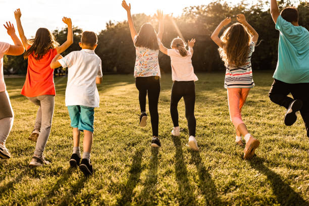 istock Happy kids running and jumping on the meadow 1327858875