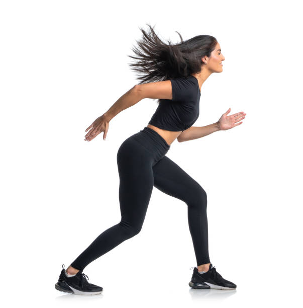 istock Sprinter woman dress in black running on white backdrop 1327860713