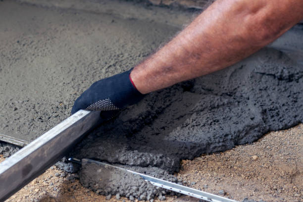 istock A worker levels the concrete floors over the beacons using a rule. 1327860742