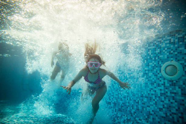 istock Two happy kids jumped into the pool 1327862030