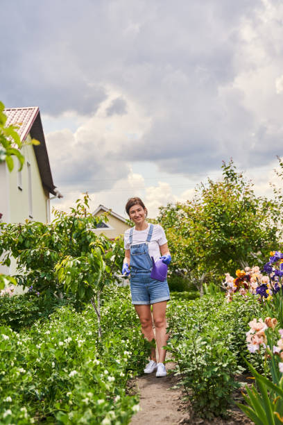 istock Female person standing with special tool for flowerbed 1327864267