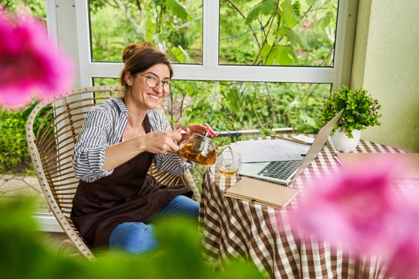istock Smiling female person having break and drinking tea 1327864364