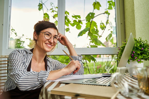 istock Smiling female person working with documents in loggia 1327864377