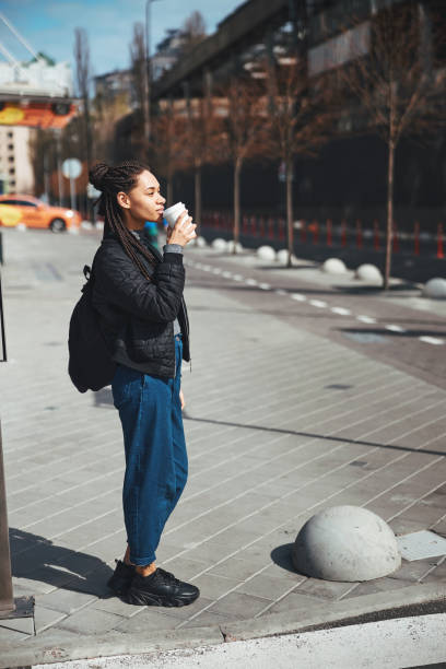 istock Taking sip of coffee while waiting for friend 1327866074