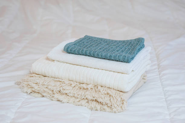 home textiles. A stack of towels lies on a white bed. High quality photo