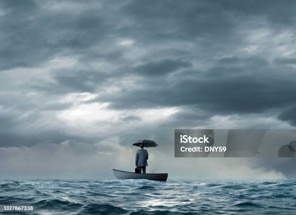Man With An Umbrella Stranded On A Boat Stock Photo - Download Image Now - Lost, Nautical Vessel, Sea