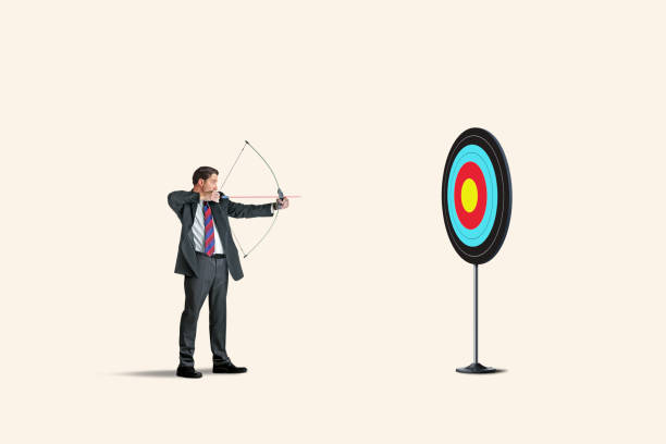 istock Man Takes Aim At Target With Bow And Arrow 1327868595