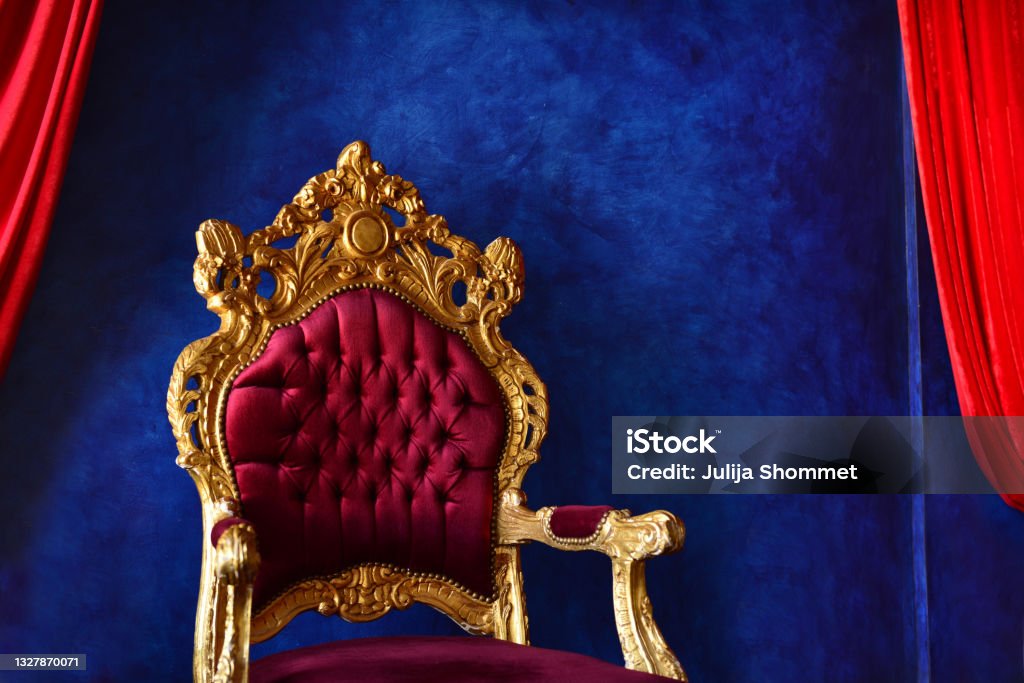 Luxury classical interior with blue wall and purple-golden chair. Extraordinary Blue And Purple Interior. Blue and red contrast with walls.Expensive home interior with violet armchair. Throne Stock Photo