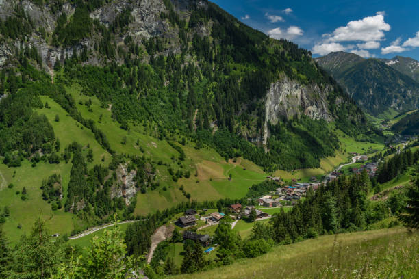 istock Summer valley with Grossarler Ache small river and blue cloudy sky 1327870251