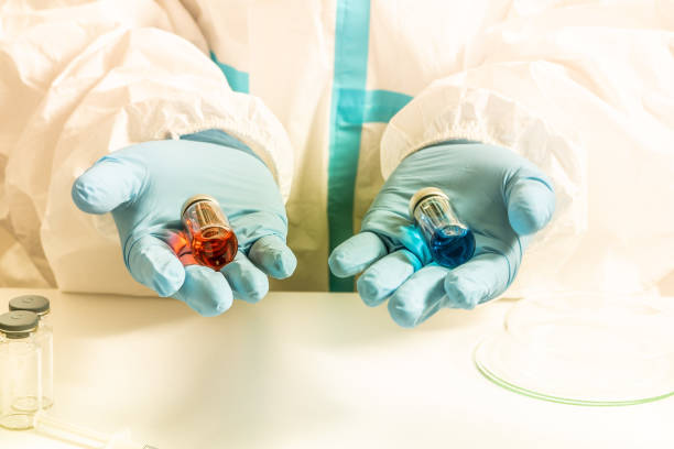 istock Different Covid 19 vaccines presented by laboratory scientist nurse. Various coronavirus vaccine choice. Pandemic prevention and immunization. Doctor in ppe shows vaccination research. 1327872696