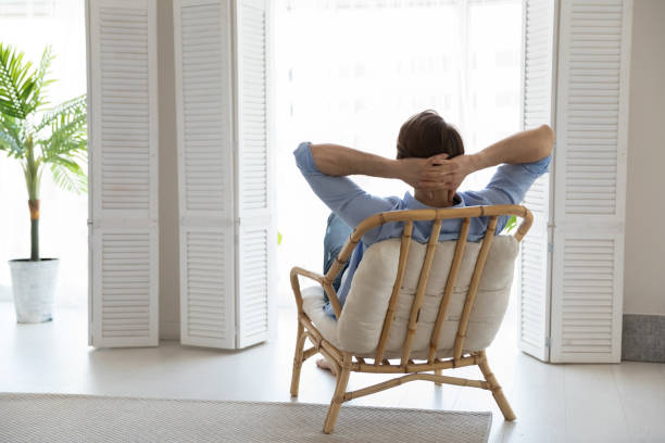 istock Relaxed young man resting in eco bamboo armchair 1327874213