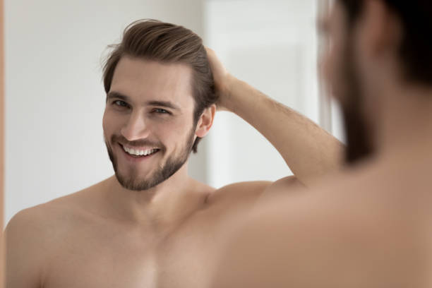 istock Happy attractive young guy touching smooth silky hair 1327874219
