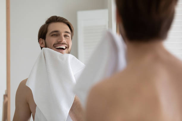 istock Happy attractive young millennial guy drying beard with white towel 1327874237