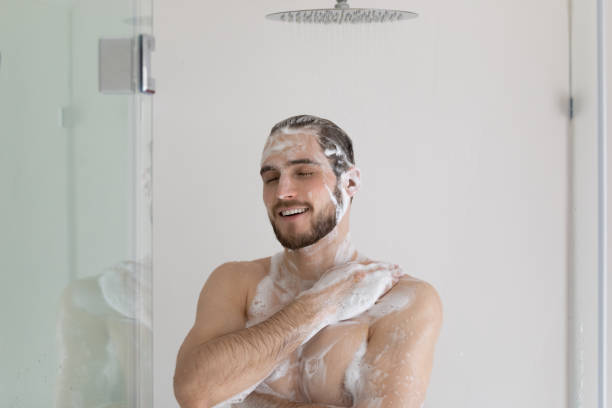 istock Happy relaxed handsome well built guy in soap gel foam 1327874247