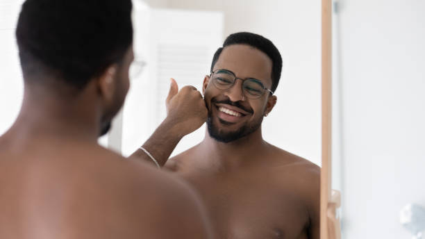istock Happy handsome mixed race Black guy in glasses touching stubble 1327874601