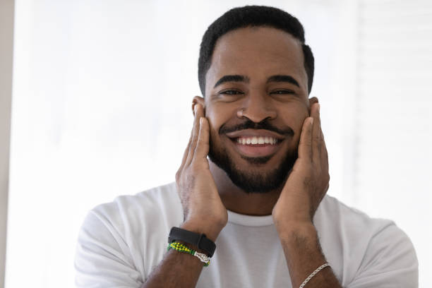 istock Happy mixed race African man touching soft stubble, stylish beard 1327874784