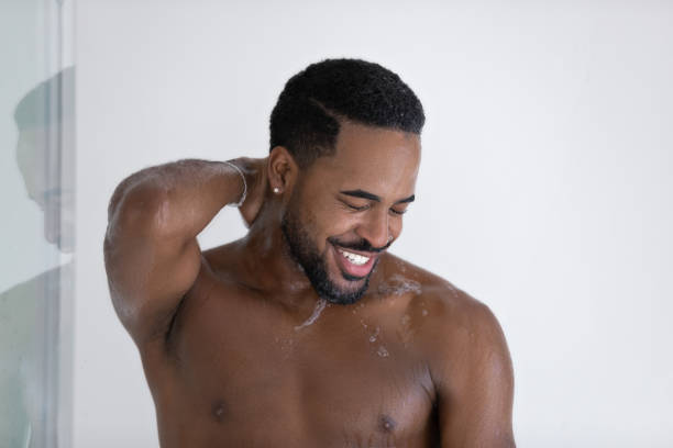 istock Happy Black guy in soap of shampoo suds taking shower 1327874785