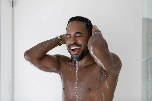 istock Happy relaxed attractive wet African guy taking shower 1327874787