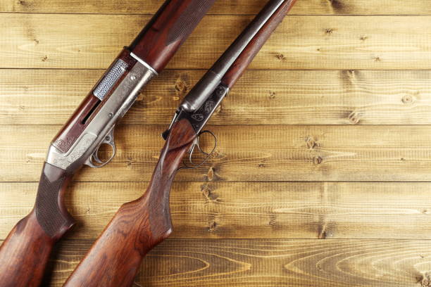 istock hunting rifles on a wooden background flat lay 1327874952