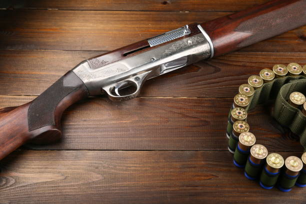 istock hunting rifle on a wooden background 1327874996