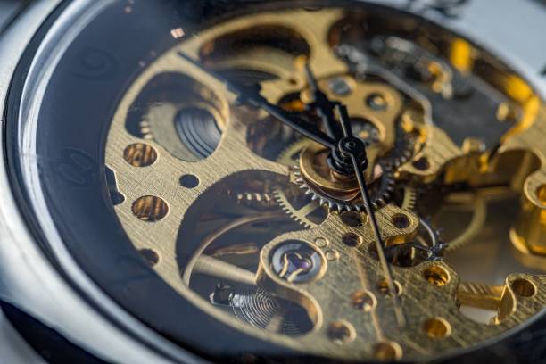 istock Gears and cogs inside clock. Close-up view on retro watches. 1327876794