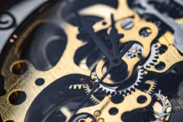 istock Gears and cogs inside clock. Close-up view on retro watches. 1327876801