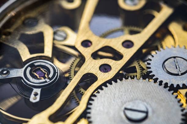 istock Gears and cogs inside clock. Close-up view on retro watches. 1327876802
