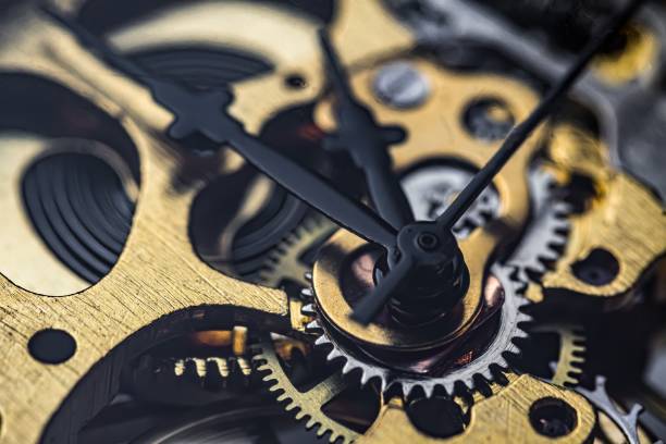 istock Gears and cogs inside clock. Close-up view on retro watches. 1327876803