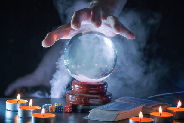 istock Magician or fortune teller is predicting future with crystal sphere. 1327876845