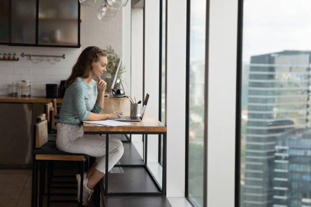 istock Happy concentrated young business lady working on computer. 1327880426