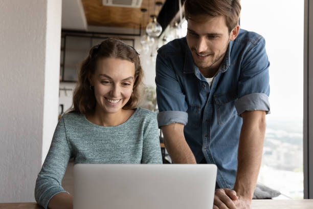 istock Happy two teammates employees working together on online project. 1327880434