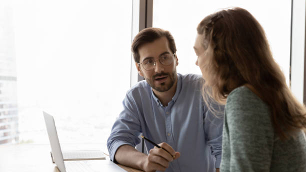 istock Concentrated young employees discussing online project in office. 1327880542