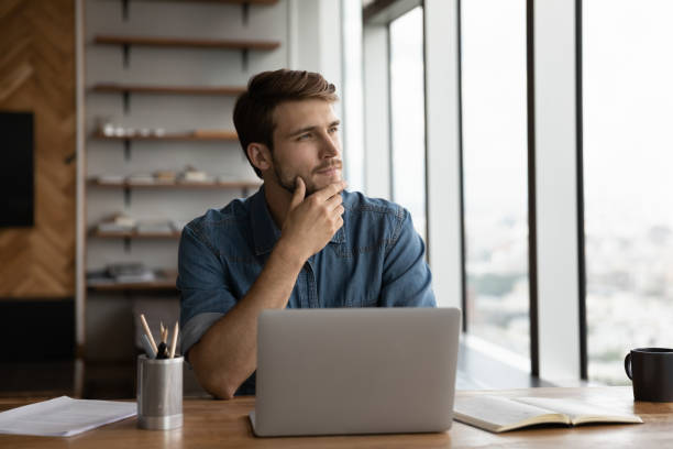 istock Thoughtful young handsome businessman looking in distance. 1327881234