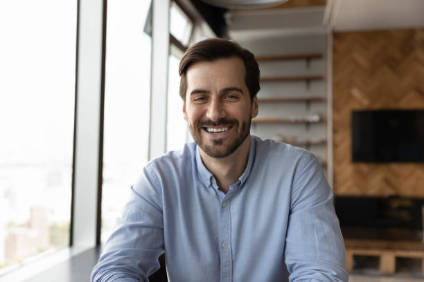 istock Smiling sincere young man looking at camera. 1327881254