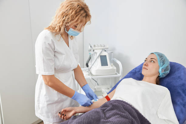 istock Professional cosmetologist is doing procedures for client in light cabinet 1327881288