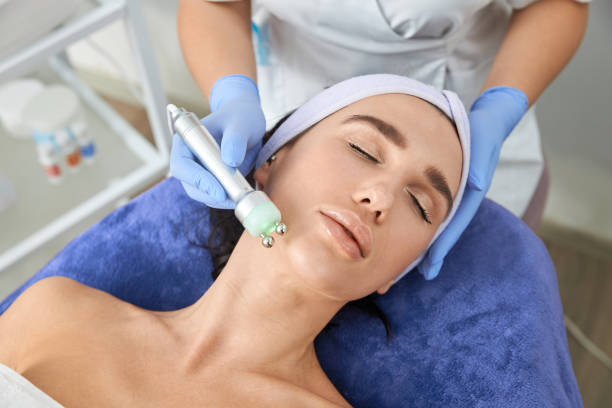 istock Professional cosmetologist is doing procedures for client in light cabinet 1327882419