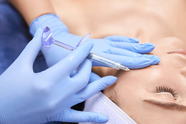 istock Professional cosmetologist is doing procedures for client in light cabinet 1327882455