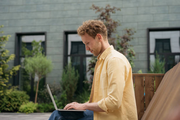 istock Business man using laptop computer, working online on the street. Successful copywriter typing, watching training courses. University student studying, distance learning, education concept 1327883682